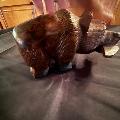 Carved small wooden bear with fish in his mouth