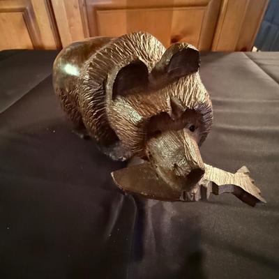 Carved small wooden bear with fish in his mouth
