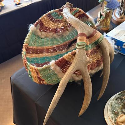 Multi-colored woven basket with deer antlers as handle