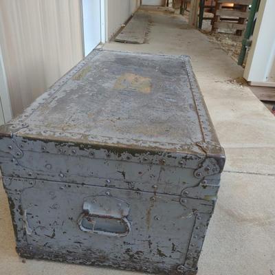 A MILITARY AND METAL TRUNKS