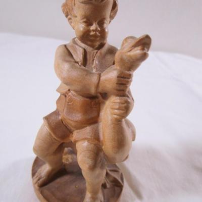 Hand-carved wood boy with goose