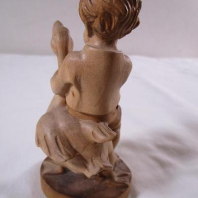 Hand-carved wood boy with goose