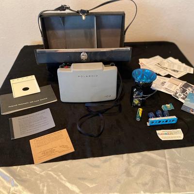POLAROID AUTOMATIC 103 CAMERA AND ALL OF ITS ACCESSORIES