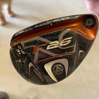 PING AND ARNOLD PALMER DRIVERS, A PIECE OF GREEN TO TEE OFF WITH A BASKET OF GOLF BALLS