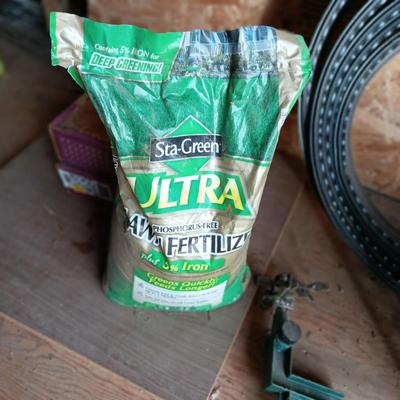 BAG OF FERTILIZER, EDGING, BUG ZAPPER AND GARDEN HOSE