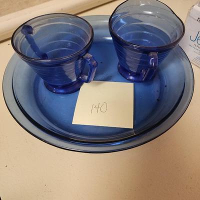 Blue glass cream and sugar and pie plate.
