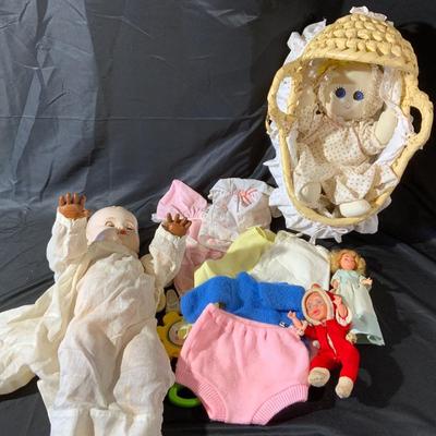 Lot of Dolls and Doll Clothes, Including a dolly bed