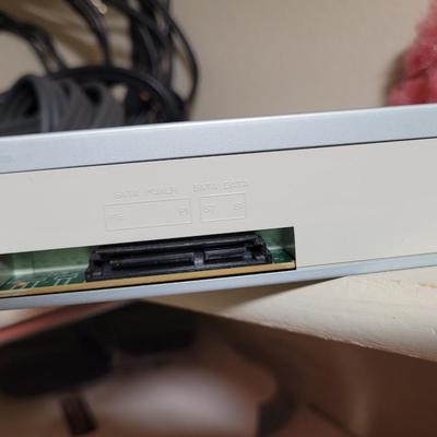 Lots and lots of cords and a zip reader and a floppy reader and a disk drive