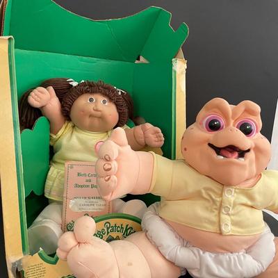 LOT 11: Adorable Cabbage Patch Doll with Adoption Papers and Baby Sinclair Talking Dinosaur (see pictures)