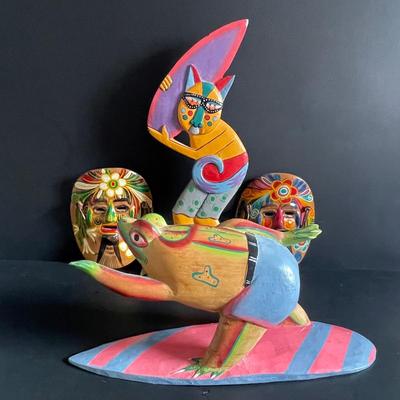 LOT:22 Colorful Collection of Hand Carved Tropical Beach Scenes and Two (2) Vibrant Hand Painted Folk Art Masks