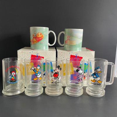 LOT 24: Winnie the Pooh & Piglet Souvenir Mugs (4.5”H), and Five (5) Vintage Glass Mugs of Assorted Disney Characters by Walt Disney...