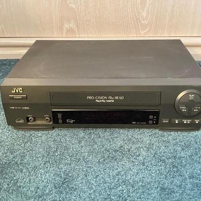 LOT 77: JVC VHS Video Cassette Recorder Player Model No HR-VP48U and Collection of Tapes and CDs