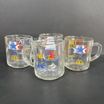 LOT 92: McDonalds Anchor Hocking Fire King Mugs, 1984 Olympic Glass Mugs, 1996 Atlanta Olympic Plates & the Four Seasons Plates