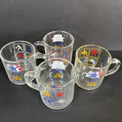 LOT 92: McDonalds Anchor Hocking Fire King Mugs, 1984 Olympic Glass Mugs, 1996 Atlanta Olympic Plates & the Four Seasons Plates