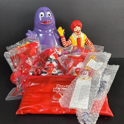 LOT 99: Vintage 1970s Ronald McDonald Plastic Bank, Ceramic Grimace Bank, Digital Watches, Character Pencils in Holder, 2004 Ty McDonalds...