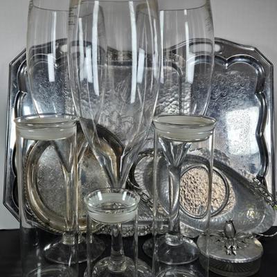 LOT 111: Oversized Centerpiece Champagne Glasses, Silver Trays, Zens Glass Canister Set, Hand Wrought Creations by Rodney Kent Trays...
