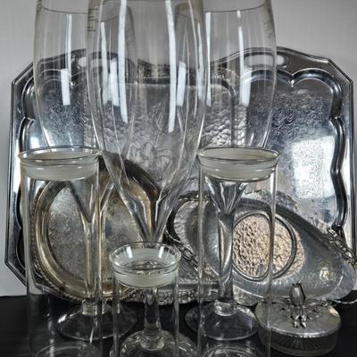 LOT 111: Oversized Centerpiece Champagne Glasses, Silver Trays, Zens Glass Canister Set, Hand Wrought Creations by Rodney Kent Trays...