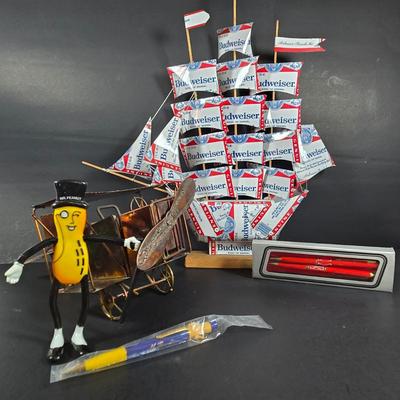 LOT 133: Handcrafted "BUDWEISER" Sailboat, BUDWEISER Pens, MR. PEANUT Bendable Figure, MR. PEANUT Pen, & Vintage Metal...