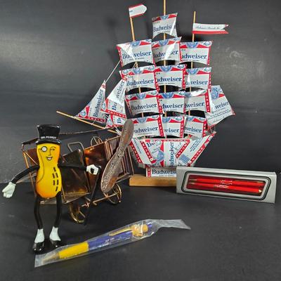 LOT 133: Handcrafted "BUDWEISER" Sailboat, BUDWEISER Pens, MR. PEANUT Bendable Figure, MR. PEANUT Pen, & Vintage Metal...