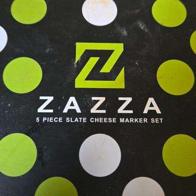 LOT 30K: Nambre Cheese Cutting Board With Knife, Zazza Knife and Serving Set, and Zazza 5 Piece Slate Cheese Marker Set