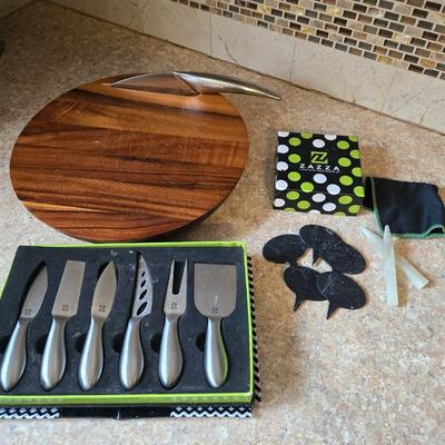 LOT 30K: Nambre Cheese Cutting Board With Knife, Zazza Knife and Serving Set, and Zazza 5 Piece Slate Cheese Marker Set
