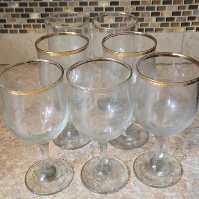 LOT 34K: Set of 12 Pasabahce Circle Art of Glass Gold Rim Glasses, Set of 7 Fostoria Classic Gold Water Goblets, and Set of 4 Artland...