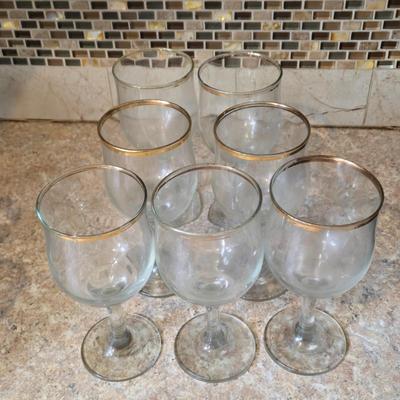 LOT 34K: Set of 12 Pasabahce Circle Art of Glass Gold Rim Glasses, Set of 7 Fostoria Classic Gold Water Goblets, and Set of 4 Artland...
