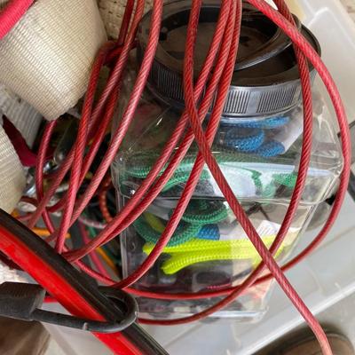 Lot 438 box of tie down straps, bungee cords and jumper cables