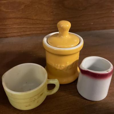 Small plates and cups with mustard jar
