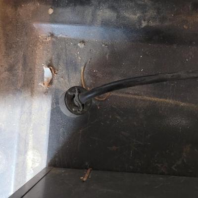 Rolling cabinet filled with tools with electrical receptacles