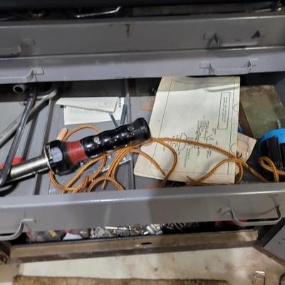 Rolling cabinet filled with tools with electrical receptacles