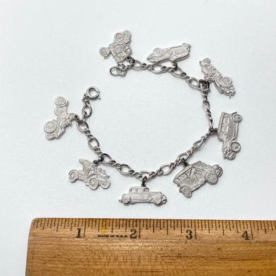 LOT 239: Sterling Silver AAA Charm Bracelet - TW 25.85g
