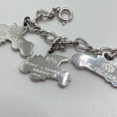 LOT 239: Sterling Silver AAA Charm Bracelet - TW 25.85g