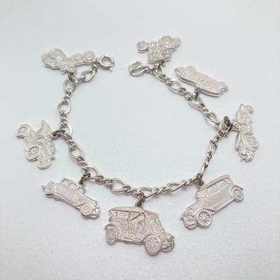 LOT 239: Sterling Silver AAA Charm Bracelet - TW 25.85g