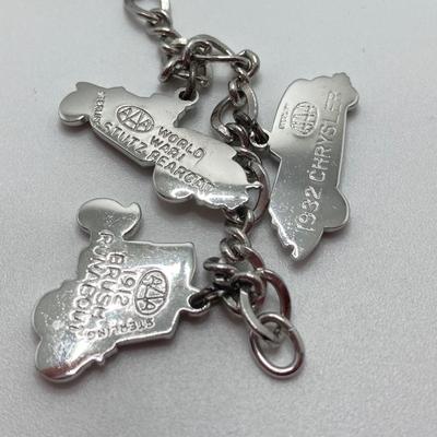 LOT 239: Sterling Silver AAA Charm Bracelet - TW 25.85g