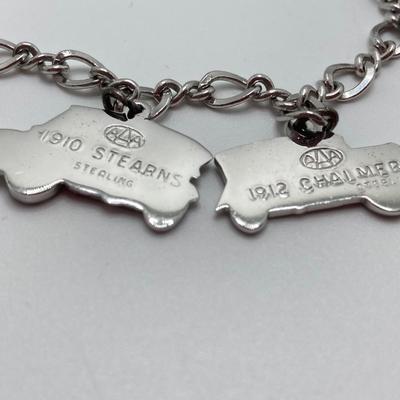 LOT 239: Sterling Silver AAA Charm Bracelet - TW 25.85g