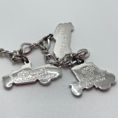 LOT 239: Sterling Silver AAA Charm Bracelet - TW 25.85g