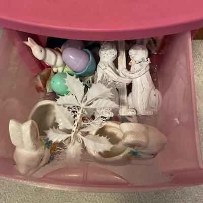 Pink plastic storage with Easter decor and wind chime