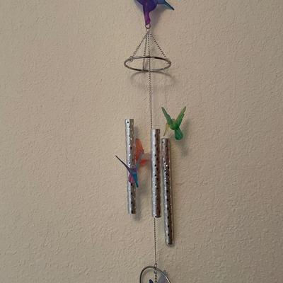 Pink plastic storage with Easter decor and wind chime