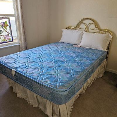 Queen Sized bed with decorative brass headboard