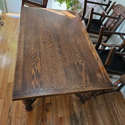 Antique English Jacobean Revival Oak table with pull out end leaves and six chairs