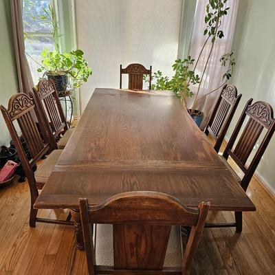Antique English Jacobean Revival Oak table with pull out end leaves and six chairs