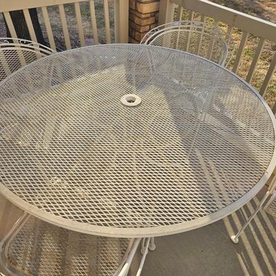 Heavy wrought iron patio table with Four nice chairs with cushions