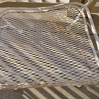 Heavy wrought iron patio table with Four nice chairs with cushions