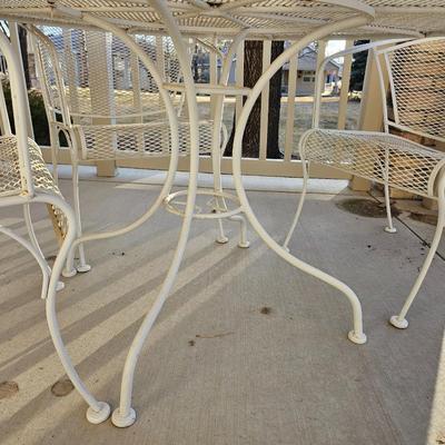 Heavy wrought iron patio table with Four nice chairs with cushions