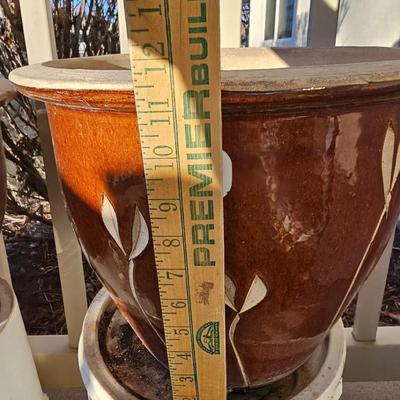 Two matching beautiful clay pottery flowerpots with leaf designs