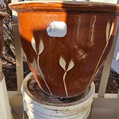 Two matching beautiful clay pottery flowerpots with leaf designs