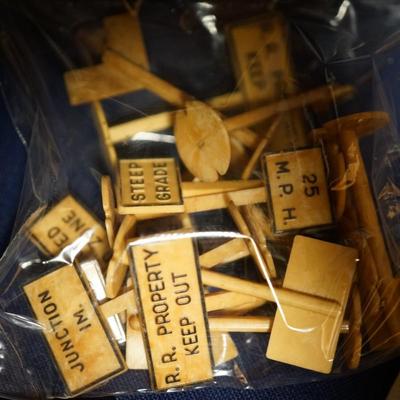 MODEL TRAIN COLLECTIBLES. LIONEL TRAIN BAGS OF COAL, BILLBOARD SIGNS AND TRACK POST SIGNS