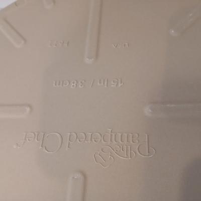Pampered Chef 15 inch handled pizza stone with glass cutting board and a lidded metal cake pan
