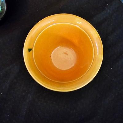 Small orange enamel sugar dish with hand painted wooden wall art, chalkware fruit and more